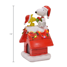 Load image into Gallery viewer, Peanuts Snoopy&#39;s Dog House Tabletop Holiday Figurine with LED Christmas Lights, 7.5 Inch
